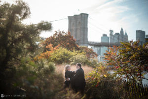 Capture beautiful summer moments with a note of romance during an engagement photography session on the iconic Brooklyn Bridge.