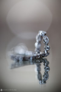 A close up of a diamond ring on a wedding table.