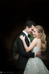 A bride and groom blissfully embracing in the romantic ambiance of a tunnel at their extraordinary Yale Club wedding.