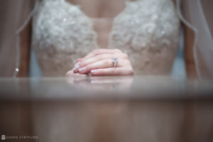 At the Yale Club, a bride delicately holds her wedding ring on a table.