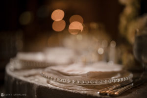 A table setting with silverware and silverware on a table at a wedding reception in the Yale Club.