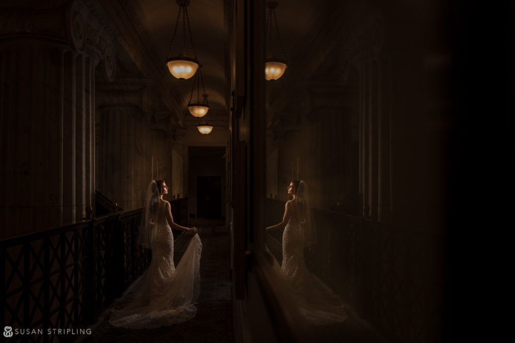 A Philadelphia bride in a wedding dress standing in the hallway of the Ritz Carlton.