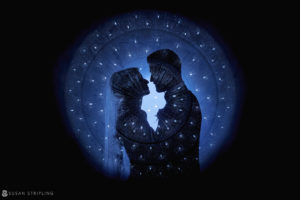 A silhouette of a couple kissing in the romantic darkness of their Philadelphia wedding at the Ritz Carlton.