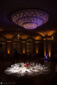 A table set up in the Carlton ballroom with a chandelier.