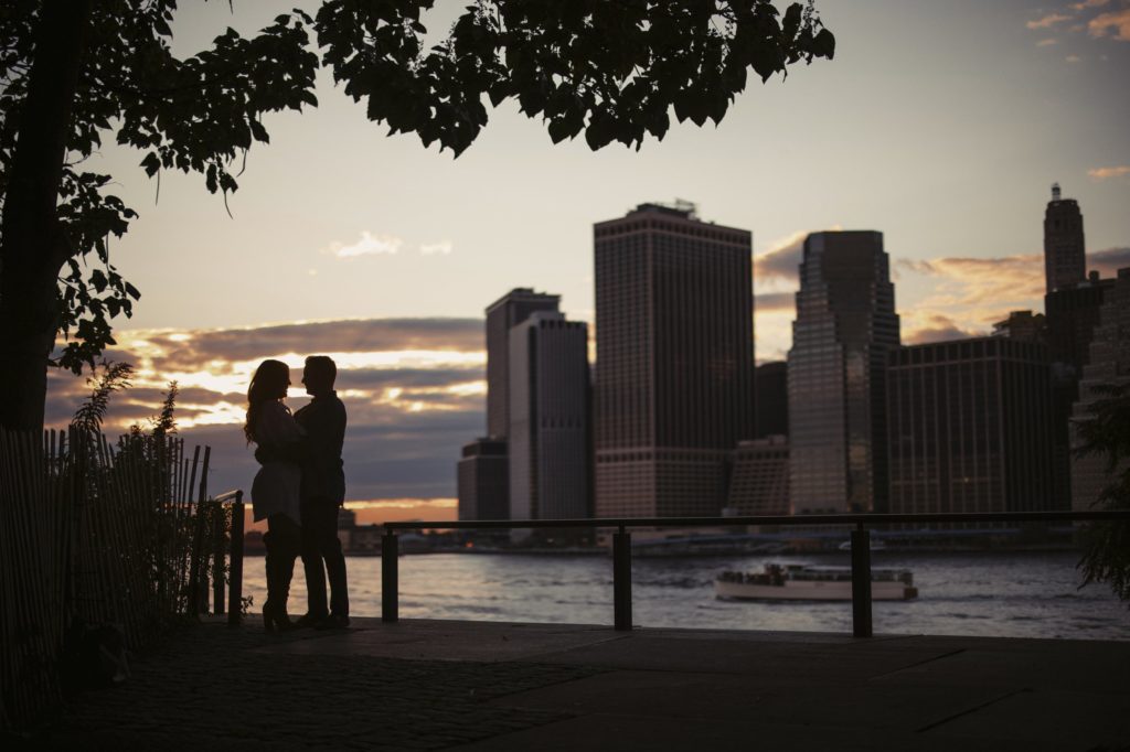 A silhouette of a couple standing in front of the city skyline at The Estate at Florentine Gardens.