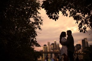 A couple embraces under a tree at The Estate at Florentine Gardens at sunset.