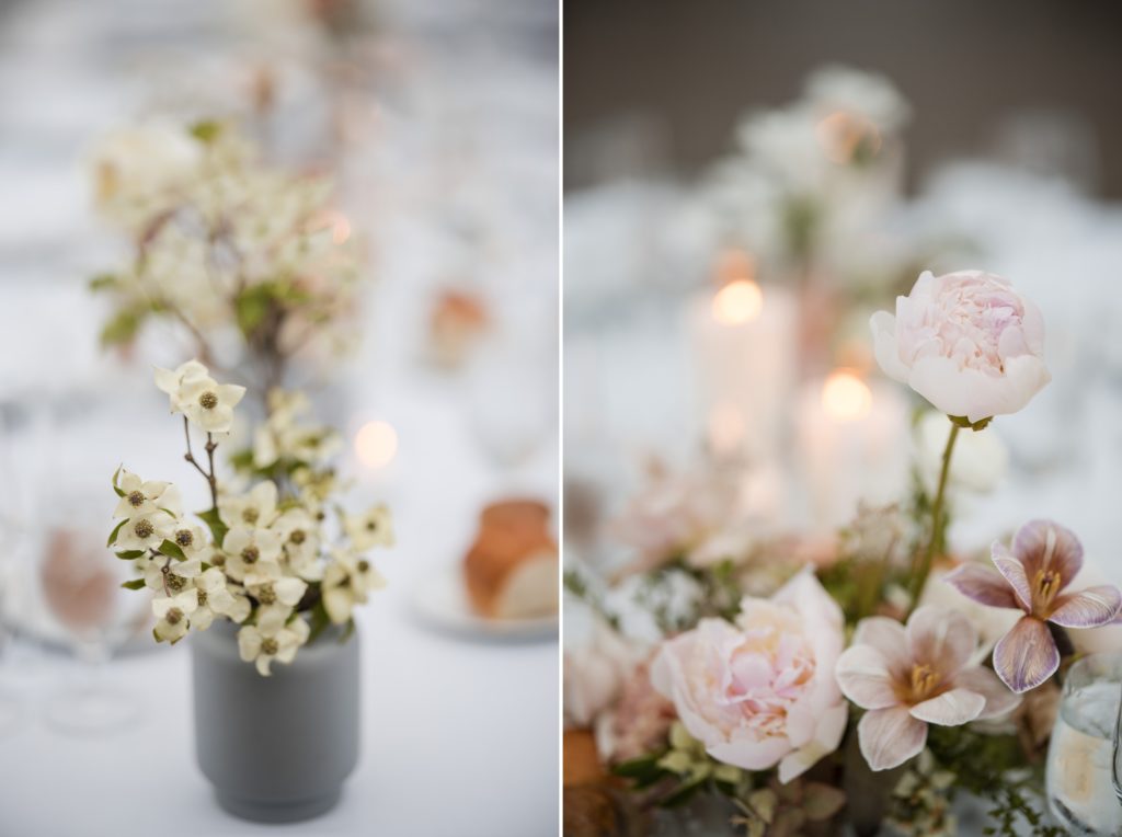 A table with flowers and candles on it at a rainy summer wedding in the Brooklyn Botanic Garden.