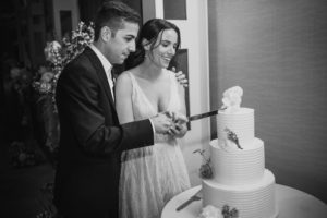 A bride and groom cutting their wedding cake at the Brooklyn Botanic Garden.