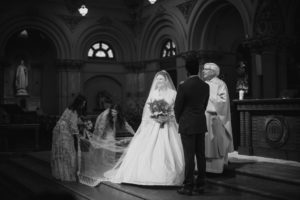 A black and white wedding photo of a bride and groom in St. Francis Xavier church.