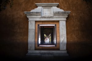 A Ritz Carlton wedding with the bride and groom standing in front of a window at Dorado Beach.