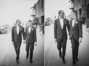 Two men in tuxedos walking down the street near Liberty Warehouse.