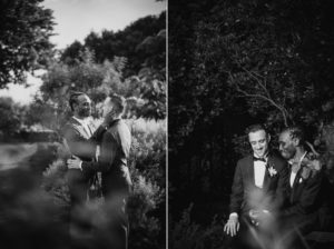 A black and white photo of two men in tuxedos at a wedding.