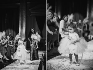 A little girl is walking down the aisle at a wedding at Capitale in NYC.