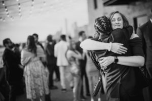 A man and woman hugging at a wedding reception held at Liberty Warehouse.