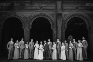 A black and white photo of a wedding party at Wallace and the Loeb Boathouse.