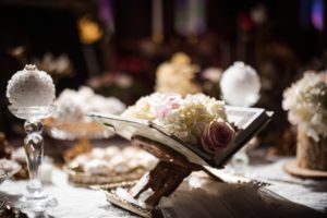 A wedding table adorned with a book and flowers at Capitale in NYC.