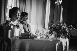 A bride and groom celebrating their wedding at the Yale Club in a room decorated with elegance and style.