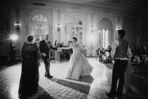 A bride and groom dancing at their St. Francis Xavier wedding in a ballroom.