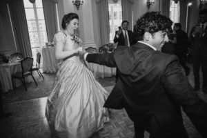 A couple gracefully dancing at their elegant wedding reception held at the prestigious Yale Club, and surrounded by the warm ambiance of St. Francis Xavier Church.