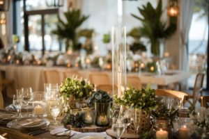 A wedding table setting at the Ritz-Carlton Dorado Beach adorned with candles and greenery.