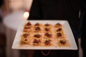 A man is holding a tray of appetizers at a wedding in Capitale, NYC.