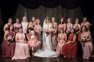 A bride and her bridesmaids posing for a wedding photo in NYC.