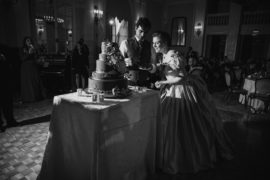 A St. Francis Xavier bride and groom cutting a wedding cake in the Yale Club ballroom.