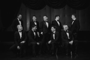A black and white photo of a group of men in tuxedos at a wedding in Capitale, NYC.