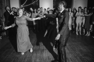 A summer wedding at Liberty Warehouse, with a man and woman dancing at the reception.