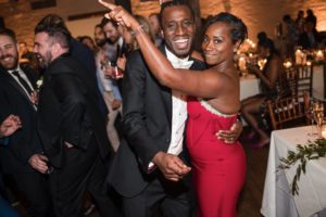 A man and woman dancing at a summer wedding reception at Liberty Warehouse.