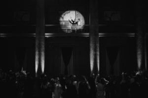A black and white wedding photo of a couple dancing in the dark room of Capitale, NYC.