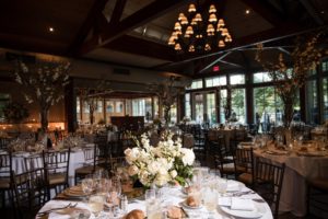 A Wallace and Loeb Boathouse wedding reception, elegantly set up in a large room.
