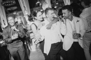 Black and white photo of a group of people at a wedding party at the Ritz Carlton, Dorado Beach.