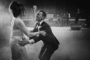 A bride and groom dancing on stage at a NYC wedding.