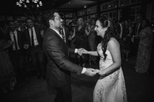 A Wallace and the Loeb Boathouse wedding reception featuring a bride and groom dancing in celebration.