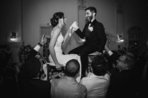 A bride and groom captured in a stunning black and white photo on their summer wedding day at the enchanting Bourne Mansion.