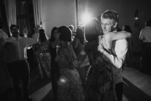 A bride and groom hugging on the dance floor at their Ritz Carlton wedding.