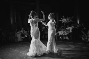 Two brides dancing on the dance floor at a NYC wedding.