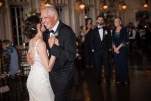 A bride and groom sharing their first dance at a summer wedding reception held at Bourne Mansion.