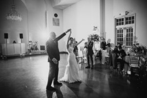 A summer wedding photo of a bride and groom dancing at Bourne Mansion.