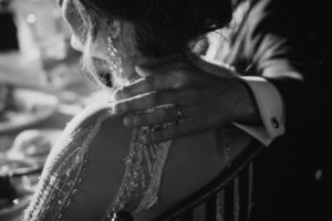 A black and white photo of a bride and groom hugging each other at their NYC wedding.