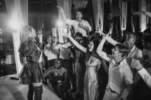 A black and white photo of a group of people at a wedding ceremony at the Ritz Carlton in Dorado Beach.