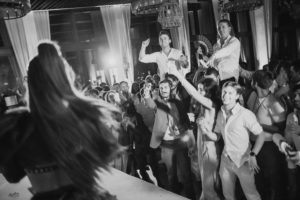 A black and white photo of a crowd at a wedding held at the Ritz Carlton.