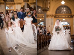 A bride walks down the aisle at her St. Francis Xavier wedding with her bridesmaids.