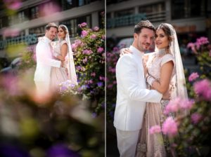 A Gotham Hall wedding with a bride and groom posing in front of flowers.