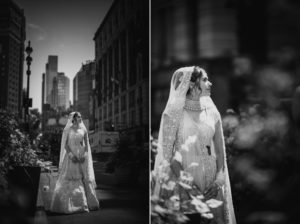 A bride is gracefully walking down the street, adorned in a stunning wedding dress.