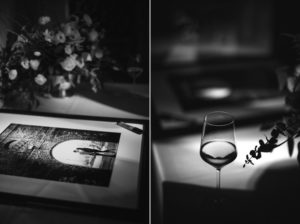 A glass of wine and a picture on a table at Gotham Hall during a wedding.