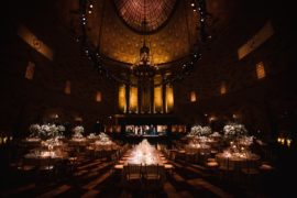 A wedding reception at Gotham Hall, with a grand chandelier in the large room.