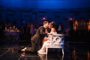 A bride and groom kissing at Gotham Hall during their wedding reception.