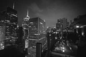 A black and white photo of a rooftop in New York City with a Gotham Hall wedding.